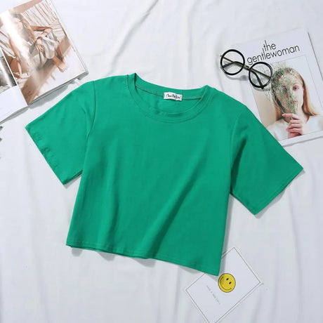 Lush green Femzai Solid Crop Tee, a fresh addition to femboy clothes, displayed prominently on a white surface.