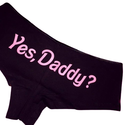 Top side view of Femzai's Yes Daddy Panties in a striking pink on black color combination, showcasing the playful embroidery and high-rise design.