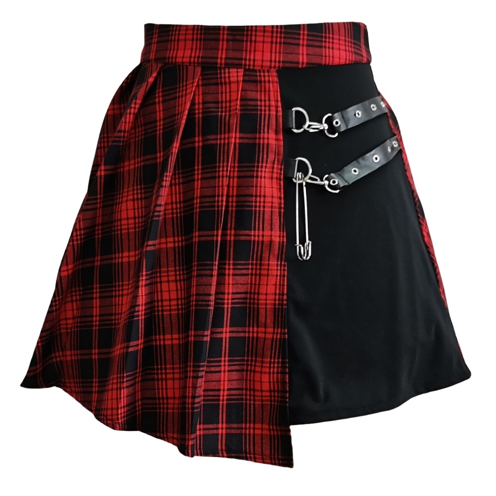 Close-up view of a Femzai Asymmetrical Pleated Skirt with a red plaid and solid black design, embodying the femboy clothing aesthetic. The skirt features a dynamic, diagonal cut with silver D-ring accents and a faux leather strap for a punk-inspired look.