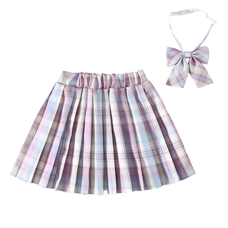 Full view of a Femzai Lightly Gridded Skirt in pastel shades with a complementary bow tie, an ideal choice for anyone embracing femboy clothing. The delicate grid design and pleats offer a classic silhouette with a modern twist.