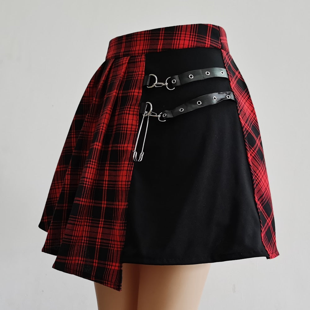Medium shot displaying the front view of a Femzai Asymmetrical Pleated Skirt, tailored for the femboy clothing line. The mix of red plaid and black fabric is accented by silver hardware and a bold, angular hemline, highlighting the skirt's unique and modern style.