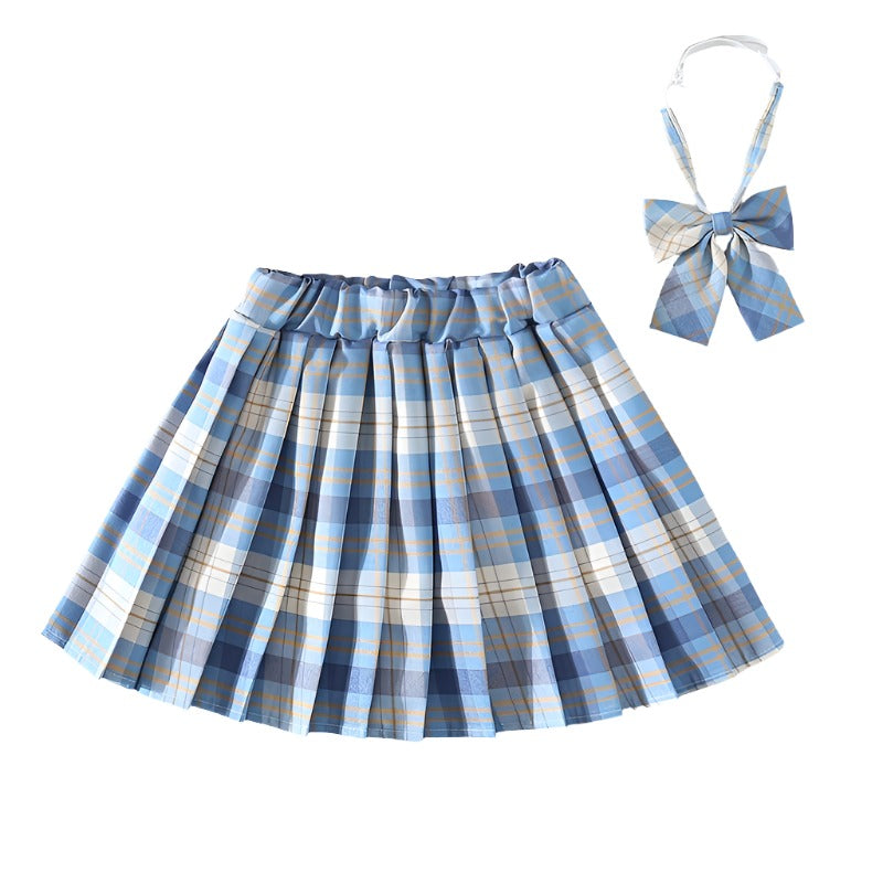 Close-up shot of a Femzai Lightly Gridded Skirt in blue, complete with a matching bow tie, offering a fresh take on femboy clothing. The skirt’s pleated design and soft color palette of blues and creams are perfect for a playful yet stylish look.