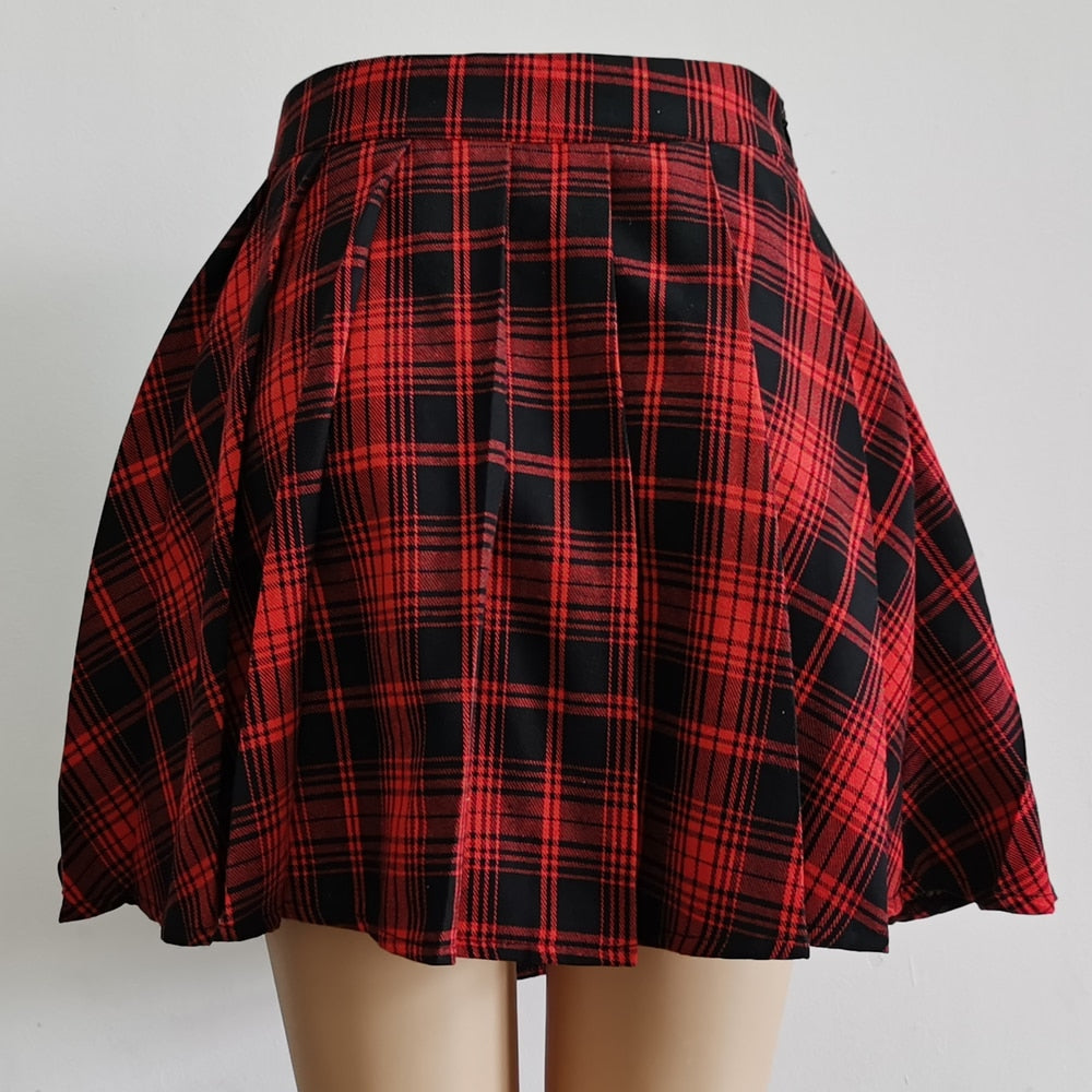 Rear view of a Femzai Asymmetrical Pleated Skirt in red plaid, perfect for adding a twist to the femboy clothing trend. The pleats create a flared silhouette, while the contrasting black panel adds a touch of contemporary edge to the traditional pattern.