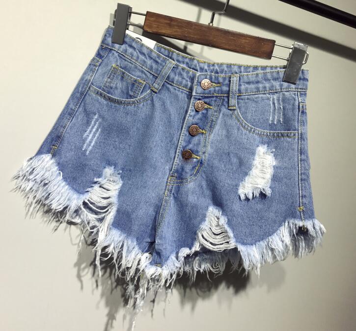 Front view of a blue Femzai denim skirt hanging on a hanger, showcasing its color and style as a key piece in femboy attire.