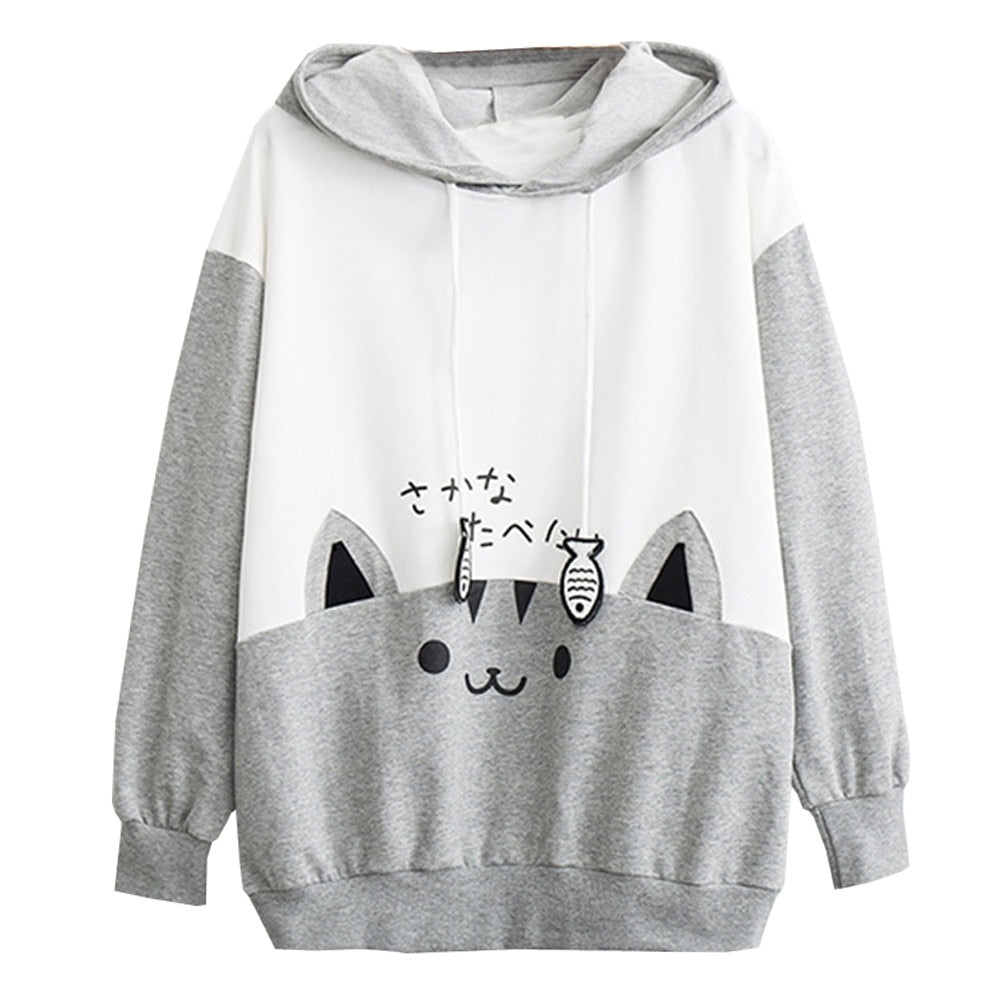 Close-up front view of a Femzai Comfy Kitten & Fish hoodie in gray with white sleeves, featuring a cute cat face and fish symbols, tailored for the femboy clothing line. The shot emphasizes the hoodie's soft texture, comfortable fit, and the playful design appealing to a trendy, youthful audience.