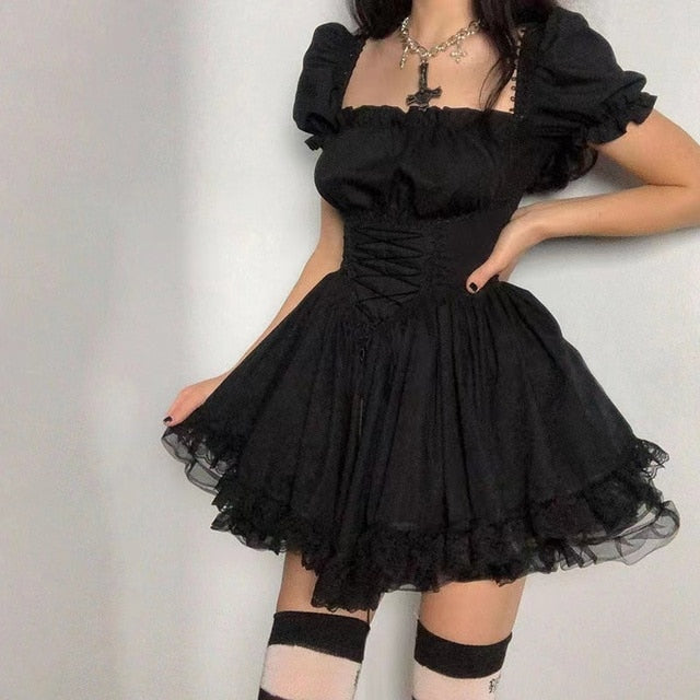 Front view of a model donning the Femzai Puff Sleeve Goth Dress in black, highlighting the bold puff sleeves and sleek A-line design, a distinctive addition to femboy clothing.