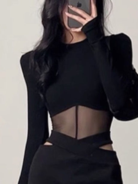 Close-up selfie of a stylish black sheer top from our femboy clothing collection, showcasing the intricate details and form-fitting silhouette against a clean white background.