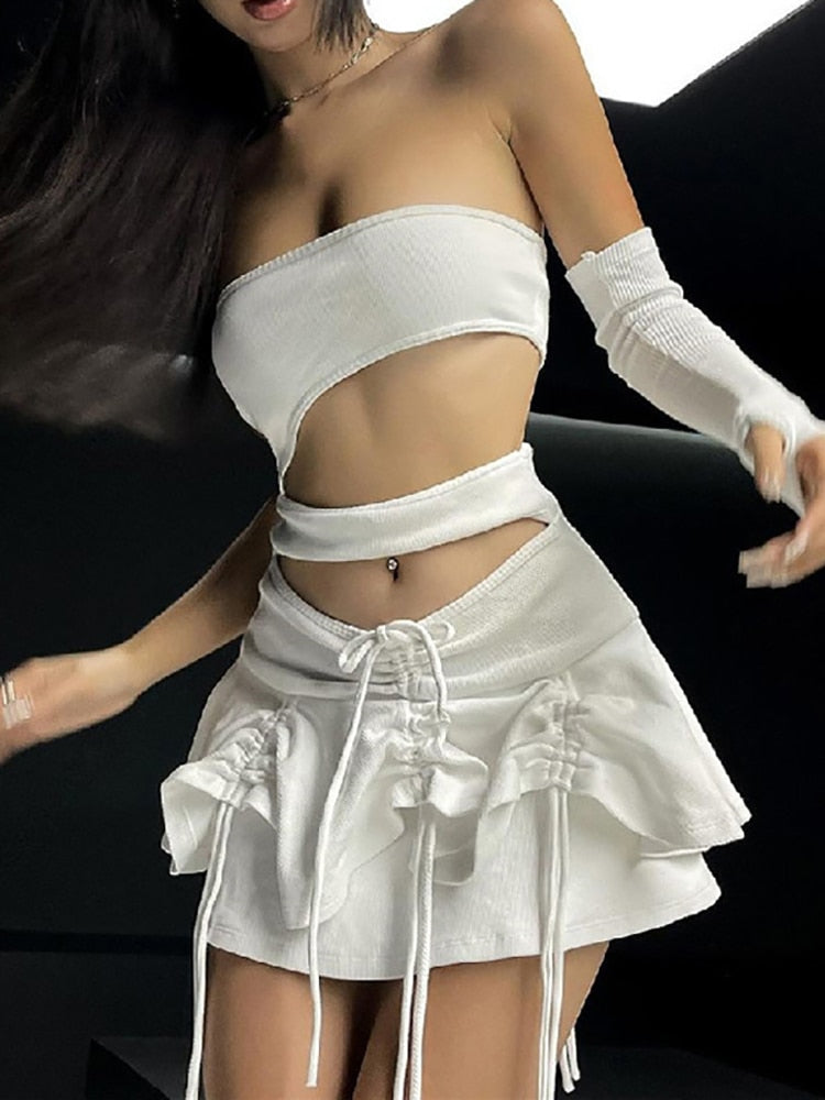 Femzai Hollow Crop Top and Skirt Set in a close-up shot, emphasizing the intricate lace details, captured from above the thighs without the model's face against a black background.