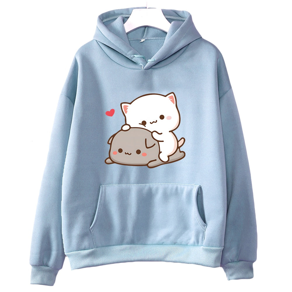 Frontal shot of a Femzai sky-blue hoodie adorned with the Peach & Goma cat illustration, tailored for the femboy clothing style. The hoodie is presented in a full view, detailing the endearing cat characters in a tender cuddle and a single red heart floating above, against a clean backdrop to draw attention to the hoodie's pastel blue shade and soft fabric texture.