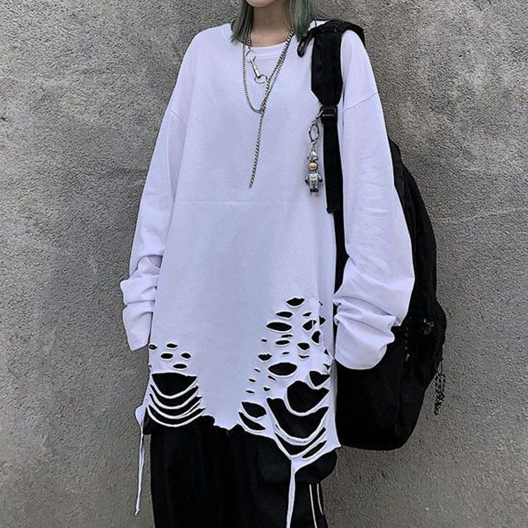 Medium shot front view of a white distressed oversized sweatshirt from Femzai featuring cut-out detailing and adjustable drawstrings, paired with black bottoms and accessorized with a layered necklace, creating an edgy androgynous look perfect for femboy fashion enthusiasts.