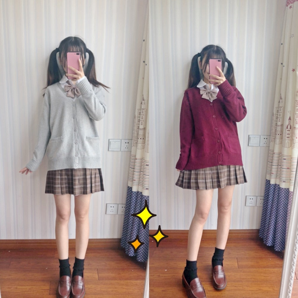 Two images of a model wearing Femzai's JK sweaters in gray and maroon, styled with a brown plaid skirt and bow ties, reflecting the soft and approachable side of femboy clothing. The mirror selfies highlight the sweaters' comfortable fit and timeless design.