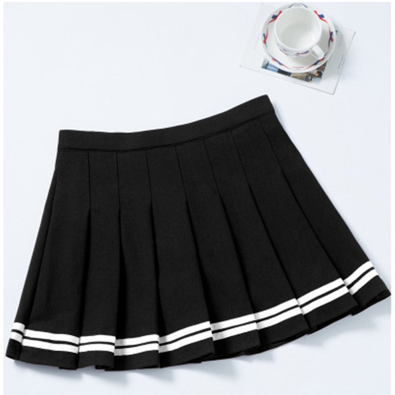 Close-up shot of a black pleated mini skirt with white stripes, part of Femzai's femboy clothing line, presented on a clean white background to highlight the skirt's crisp design and sporty aesthetic.